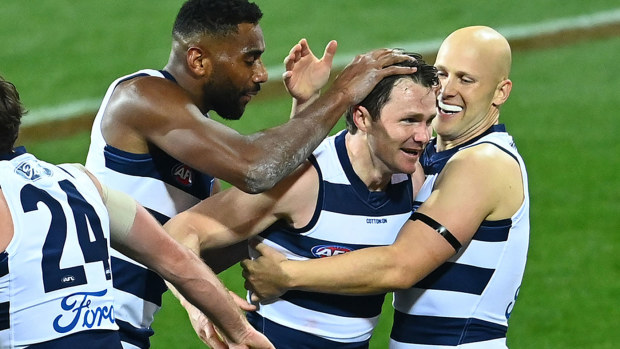 Patrick Dangerfield of the Cats is congratulated by team mates after kicking a goal 