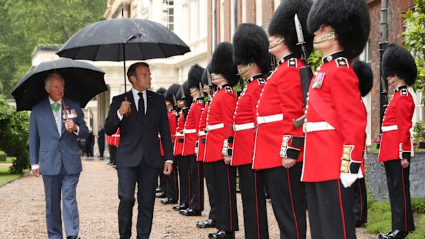 Prince Charles, Prince of Wales and Camilla, Duchess of Cornwall greet French President Emmanuel Macron with a namaste gesture as he arrives at Clarence House on June 18, 2020 in London, England
