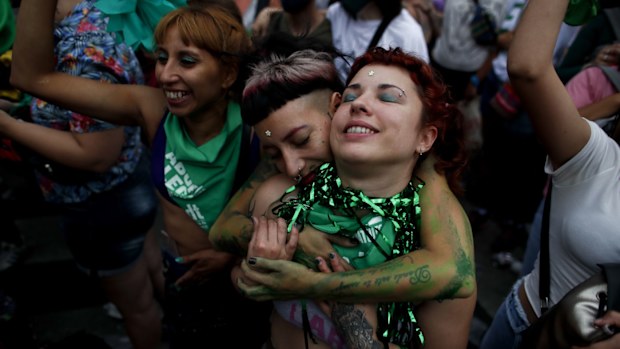 Abortion-rights activists celebrate as Argentine lower house approves a bill that would legalise abortion outside Congress in Buenos Aires, Argentina, Friday, Dec. 11, 2020