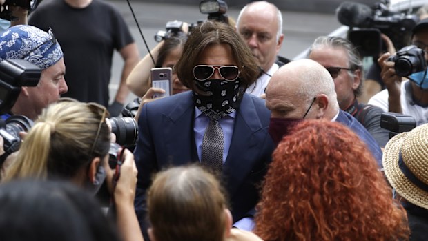 Actor Johnny Depp is surrounded by fans and the media as he arrives at the High Court in London, Friday, July 17, 2020.
