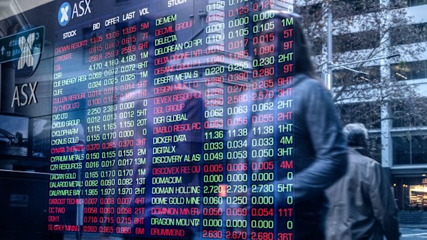 People in Sydney walk past the ASX.