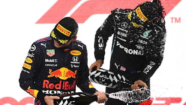Lewis Hamilton of Great Britain and Mercedes GP and second placed Max Verstappen of Netherlands and Red Bull Racing celebrate on the podium
