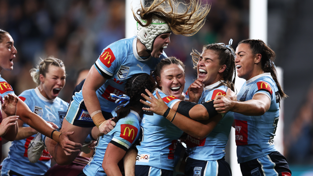 Jessica Sergis celebrates with her teammates after opening the scoring for the Blues during game one of the Women's State of Origin series.