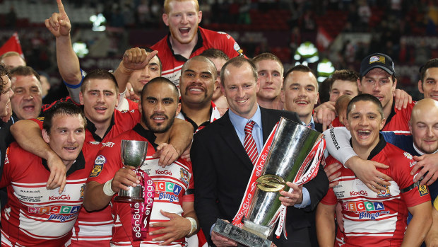 Michael Maguire the coach of Wigan Warriors lifts the engage Super League Grand Final trophy surrounded by his players after victory over St Helens in the engage Super League Grand Final between St Helens and Wigan Warriors at Old Trafford on October 2, 2010 in Manchester, England. (Photo by Alex Livesey/Getty Images)