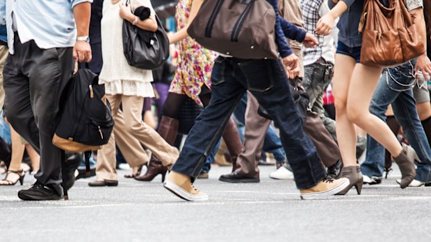 Crowd walking through city