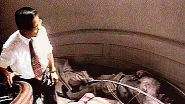 Peruvian president Alberto Fujimori walks among the corpses of the dead guerillas after the operation.