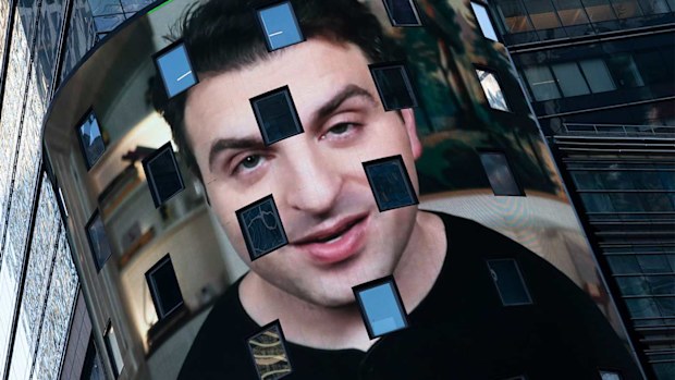 Brian Chesky, CEO of Airbnb, is shown on an electronic screen at the Nasdaq MarketSite.