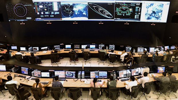 Indian scientists and engineers of Indian Space Research Organization (ISRO) monitor the Mars Orbiter Mission (MOM) at the tracking center, in Bangalore on November 27, 2013.