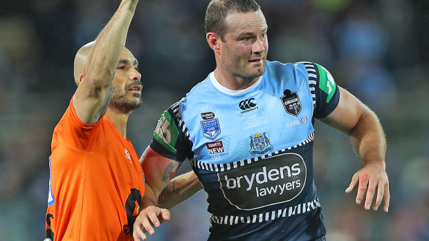 Boyd Cordner of the Blues is assisted by a trainer after a head knock