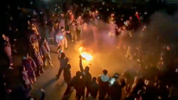 Protesters dancing and cheering around a bonfire in Iran last week.