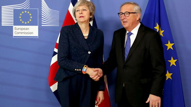 British Prime Minister Theresa May is icy as she shakes the hand of European commission President Jean-Claude Juncker.