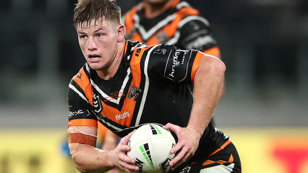 Harry Grant of the Wests Tigers runs the ball 