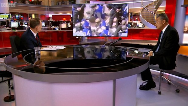 Footage of prisoners blindfolded and kneeling plays in a BBC studio, where China's ambassador to the UK, Liu Xiaoming, was being interviewed.