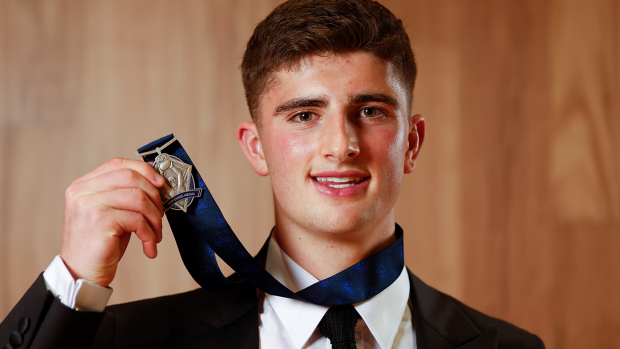 North Melbourne's Harry Sheezel poses with the Rising Star award.