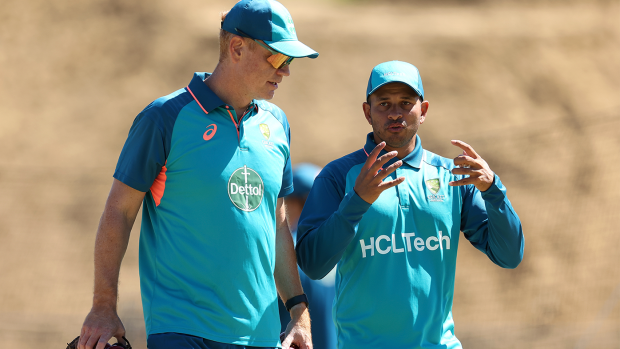 Andrew McDonald talks with Usman Khawaja during a training session in Perth.