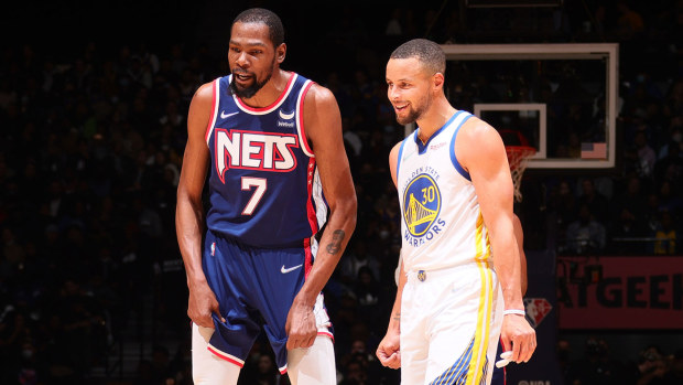  Kevin Durant #7 of the Brooklyn Nets talks with Stephen Curry #30