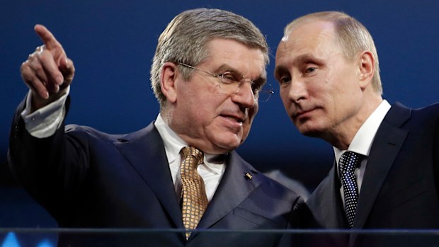 International Olympic Committee President Thomas Bach, left, and Russian President Vladimir Putin watch the closing ceremony of the 2014 Winter Olympics in Sochi. (AAP)