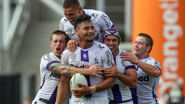 Melbourne Storm players celebrate their win over the Warriors.