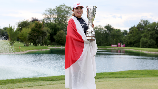 Ayaka Furue of Japan poses with the trophy after wining the Evian Championship.