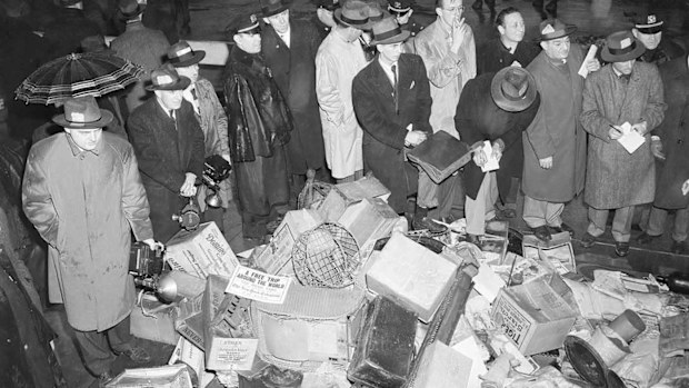 Reporters look through some of the junk from the Collyer home.
