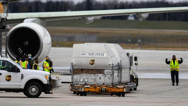 Some of the first shipments of the Pfizer COVID-19 vaccines are seen Sunday, Dec. 13, 2020, on the tarmac at Capital Region International Airport in Lansing, Michigan. (AP Photo/Matthew Dae Smith via Lansing State Journal)