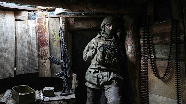 A Ukrainian serviceman stands in a shelter near Zolote