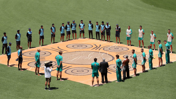 Australian and Indian players participate in a Barefoot Ceremony ahead of game one of the One Day International series between Australia and India at Sydney Cricket Ground