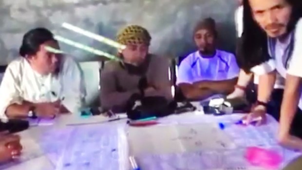The purported leader of the Islamic State group Southeast Asia branch, Isnilon Hapilon, center, at a meeting of militants at an undisclosed location.