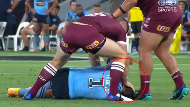 Jai Arrow pushes James Tedesco's head into the turf