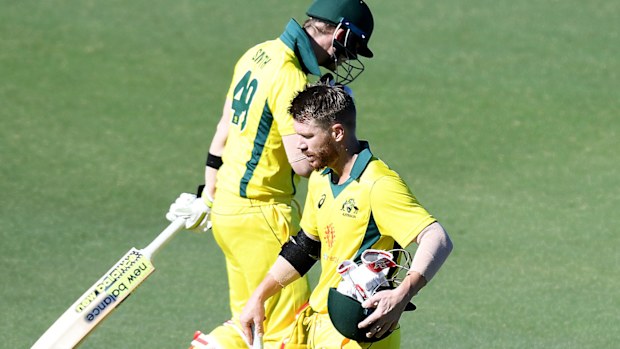 Steve Smith and David Warner cross paths during a World Cup warm-up match in Brisbane.