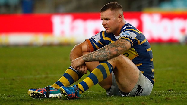 Nathan Brown of the Eels sits on the field after losing