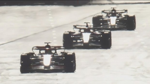 Oscar Piastri leading Charles Leclerc and Sergio Perez during the Azerbaijan Grand Prix. Leclerc and Perez both have their DRS open.