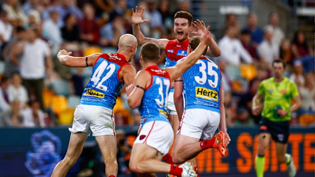 Aidan Johnson of the Demons celebrates a goal during the 2025 AFL Round 10 match between the Brisbane Lions and Melbourne
