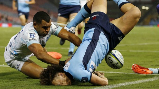 Mark Nawaqanitawase of the Waratahs lands on his face after scoring a try in the Super Rugby match against the Blues in Newcastle.