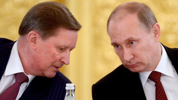 Russian President Vladimir Putin (right) speaks with his chief of staff Sergei Ivanov. (AAP)