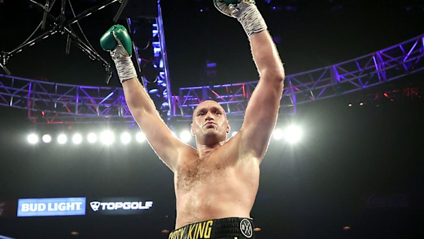 Tyson Fury celebrates after knocking down Deontay Wilder during their Heavyweight bout for Wilder's WBC and Fury's lineal heavyweight title