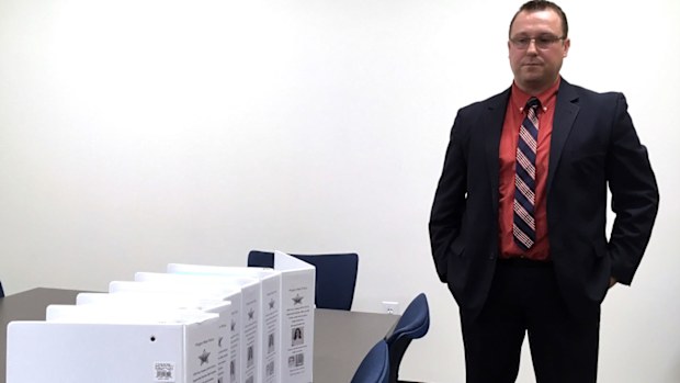  Oregon State Police Major Crimes Detective Steve Hinkle stands over files for the 38-year-old Janie Landers murder case at Oregon State Police headquarters in Salem (Marion County Sheriff's Office via AP)