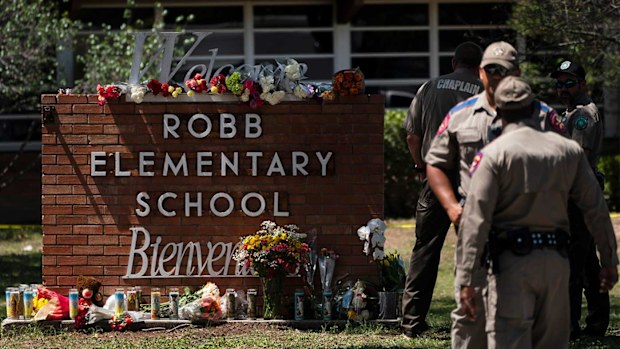 Flowers and candles are placed outside Robb Elementary School in Uvalde, Texas.
