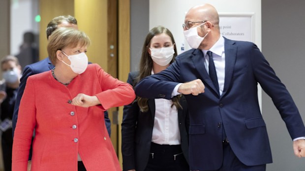 German Chancellor Angela Merkel (L) elbow bumps the President of the European Council Charles Michel (R) during an EU summit on July 17, 2020 in Brussels, Belgium. European Council President Charles Michel has called an extraordinary summit on Friday July 17 and Saturday July 18 to discuss the EU's post-coronavirus recovery plan and the 2021-2027 budget.