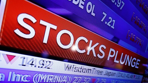 A television screen on the floor of the New York Stock Exchange headlines market activity