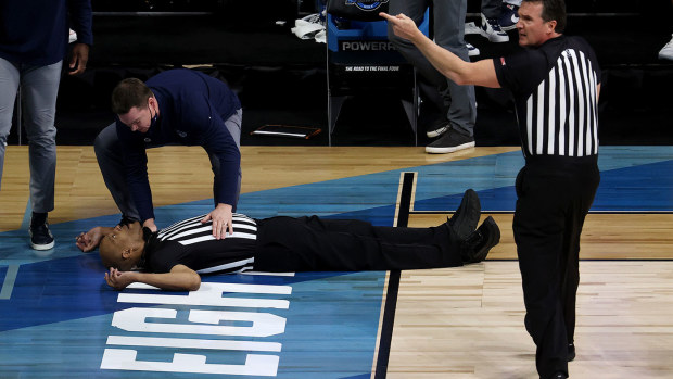 Referee Bert Smith lies on the court after collapsing during the first quarter of the NCAA Elite Eight match between USC and Gonzaga in Indiana.
