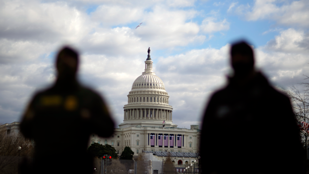Law enforcement stand near the Capitol ahead of the inauguration of President-elect Joe Biden and Vice President-elect Kamala Harris, Sunday, Jan. 17, 2021, in Washington. (AP Photo/David Goldman)