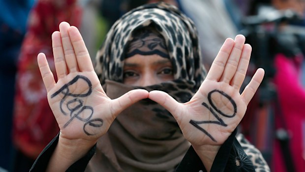 A supporter of the religious group 'Jamaat-e-Islami flashes a 'Rape No' signs during a demonstration to condemn the incident of rape on a deserted highway, in Islamabad