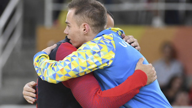 American gymnast Danell Leyva embraces Ukrainian Oleg Verniaiev who denied him the gold medal in the parallel bars. (AFP