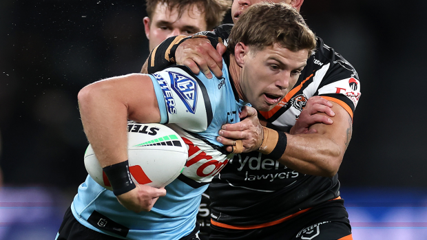 Blayke Brailey of the Sharks is tackled.