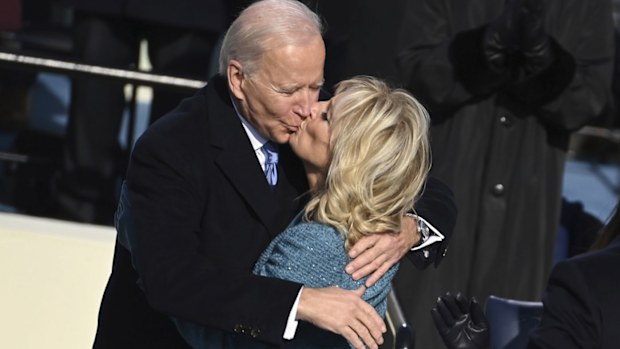 President Joe Biden gets a kiss from first lady Jill Biden after he took the oath office during the inauguration at the U.S. Capitol in Washington, Wednesday, Jan. 20, 2021