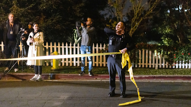 A police officer blocks off a street near Rob Reiner's residence in the Brentwood area of Los Angeles.