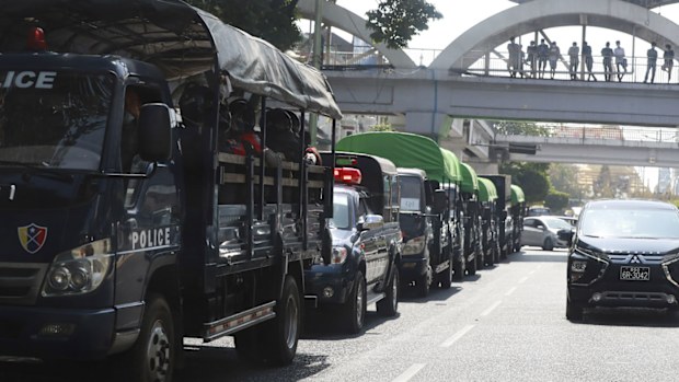 Policemen sit inside trucks parked on a road in the downtown area of Yangon, Myanmar. 