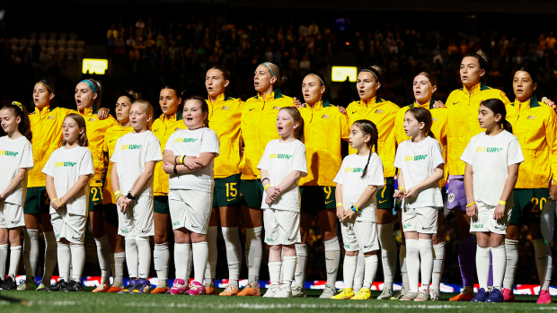 The Matildas sing the national anthem alongside young fans during the international friendly match between the Australia and France.
