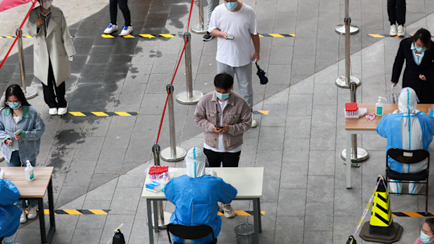 People waiting in line for nucleic acid testing at a business center in Chaoyang District on April 27, 2022 in Beijing, China.